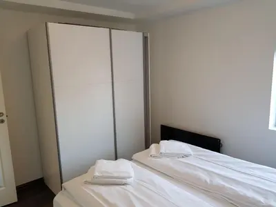 a bedroom with two white towels sitting on a bed at Lagunen Apartments in Bergen