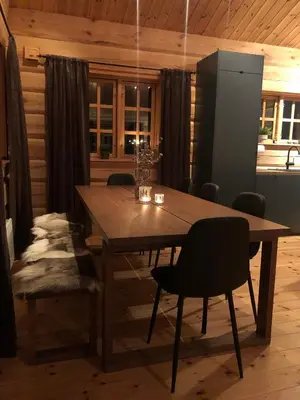 a wooden table and chairs in a room at Hyggelig laftehytte på 140kvm med Ski-In/Out in Uvdal