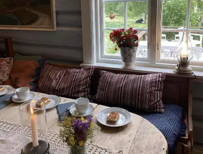 a living room with a table with food and a candle at Sevletunet B&B and Cabins in Rødberg
