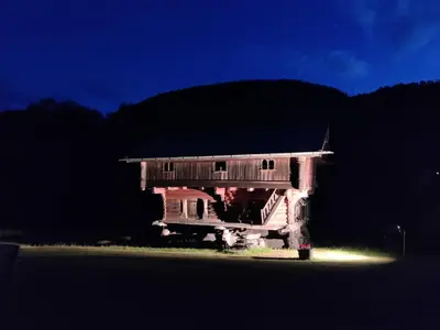 a house sitting on the side of a road at night at Sevletunet B&B and Cabins in Rødberg