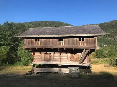 a wooden cabin in the middle of a field at Sevletunet B&B and Cabins in Rødberg