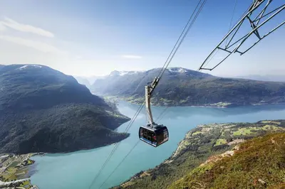 a gondola flying over a lake in the mountains at Hotel Loenfjord Loen in Loen