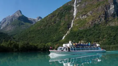a group of people on a boat on a lake at Hotel Loenfjord Loen in Loen