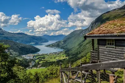 a house on a hill with a view of a lake at Hotel Loenfjord Loen in Loen