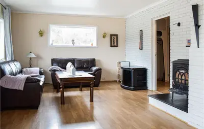 a living room with leather furniture and a fireplace at Cozy Home In Etne With Wifi in Kyrping