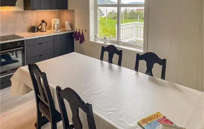 a kitchen with a table and chairs in a kitchen at Cozy Home In Etne With Wifi in Kyrping