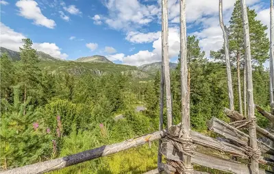 a wooden fence with mountains in the background at 4 Bedroom Stunning Home In Hemsedal in Hemsedal
