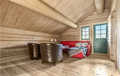 a living room with a red couch and a table at 4 Bedroom Stunning Home In Hemsedal in Hemsedal