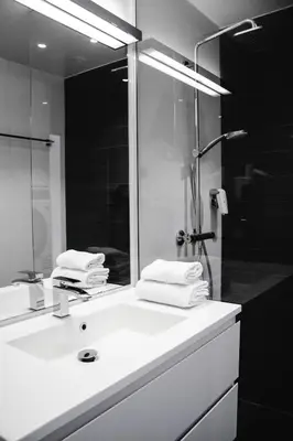 a bathroom with a sink and a shower and a mirror at Panorama Rorbusuiter in Steinsland