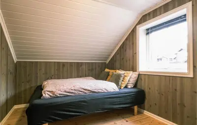 a bed in a small room with a window at Stunning Home In Rauland With Wifi in Rauland