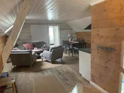 a living room with a couch and a table at Old town boutiqe apartments/ Gamle Lærdalsøyri boutique leiligheter in Lærdalsøyri