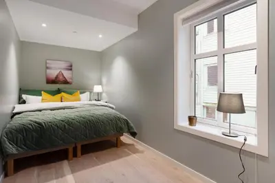 a bedroom with a bed and a window at Keyser Apartments 6 in Bergen