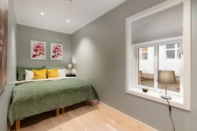 a bedroom with a bed and a window at Keyser Apartments 6 in Bergen