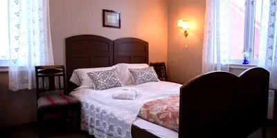 a bedroom with a large bed with pillows on it at Strømnes - Oldefars gjestehus Inderøy in Straumen