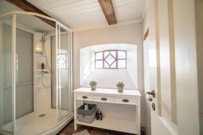 a bathroom with a walk in shower and a sink at Flatflesa Fyr - by Classic Norway Hotels in Rindarøy
