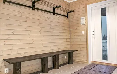 a wooden bench in a room with a window at Privat'n in Hemsedal