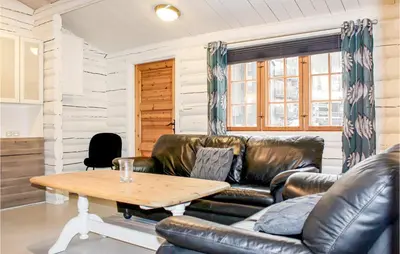 a living room with a leather couch and a coffee table at Privat'n in Hemsedal