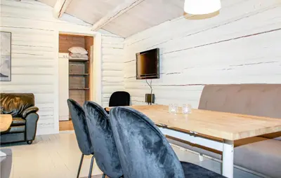 a dining room with a wooden table and chairs at Privat'n in Hemsedal