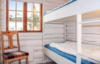 a bunk bed in a room with a chair and a ladder at Privat'n in Hemsedal