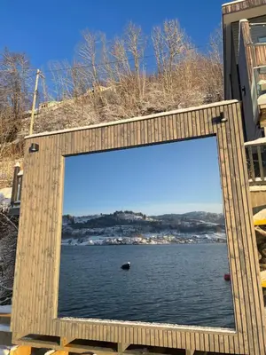 a large window with a view of a body of water at Panoramaresort in Hardangerfjorden leilighet i sjøkanten ved Hardangerfjorden for 7 personer boat , sauna,kajak, SUP for rent in Øystese