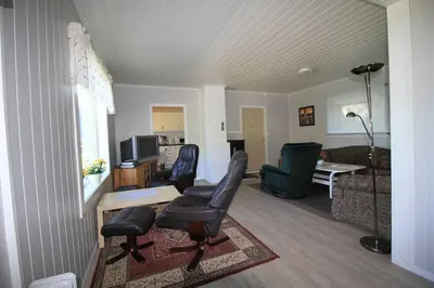a living room with two chairs and a couch at Bellahuset in Sæbø