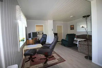 a living room with two chairs and a couch at Bellahuset in Sæbø