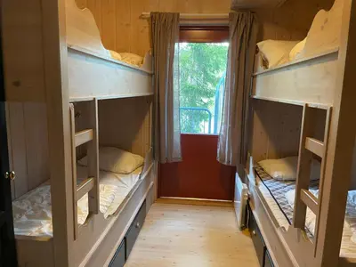 two bunk beds in a room with a window at Tinden in Hemsedal