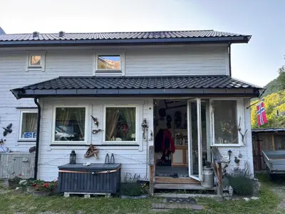 a white house with a black roof at Iris Vedal in Nauste