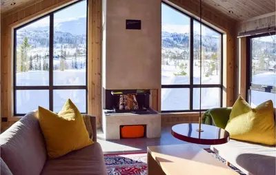 a living room with a couch and a fireplace at Amazing Home In Flå With Wifi in Flå