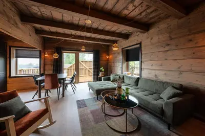 a living room with a couch and a table at Jølstraholmen Landskapshotell in Vassenden