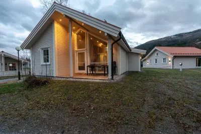 a house with a large window on the side of it at Jølstraholmen Landskapshotell in Vassenden
