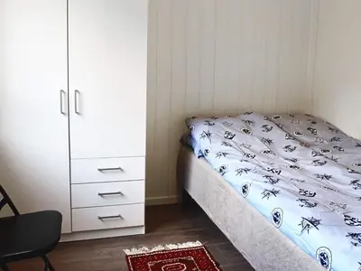 a bedroom with a bed and a white cabinet at 6 person holiday home in VATNE in Vatne