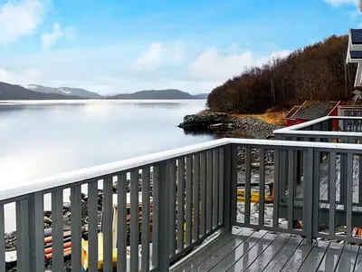 a balcony with a view of a body of water at 8 person holiday home in VATNE in Vatne