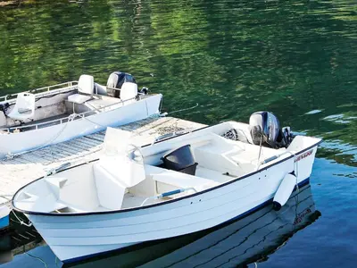 two white boats docked at a dock in the water at 8 person holiday home in VATNE in Vatne