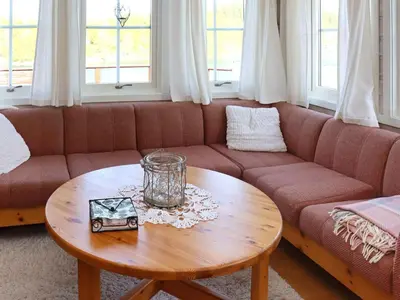 a living room with a couch and a wooden table at 7 person holiday home in KLOKKARVIK in Klokkarvik