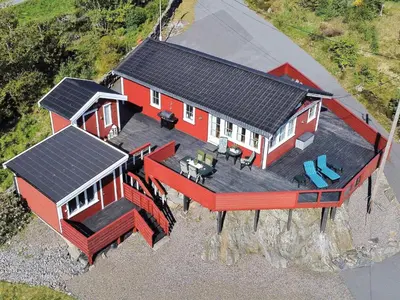 an aerial view of a red house with a deck at 7 person holiday home in KLOKKARVIK in Klokkarvik