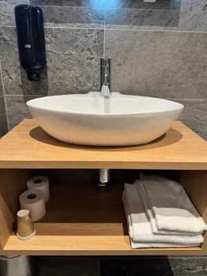 a white sink on a wooden counter in a bathroom at Toftemo Turiststasjon in Dovre