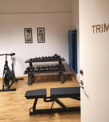 a room with a gym with a bunch of machines at Sanner Hotell in Gran