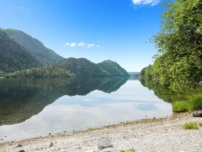 a view of a river with mountains in the background at Grimen Camping in Bergen