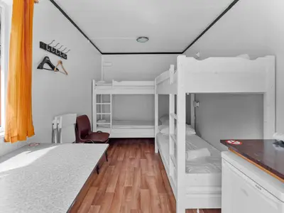 a room with two bunk beds and a desk at Grimen Camping in Bergen