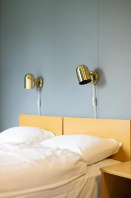 a bed with two lamps on top of it at Havly Bed & Breakfast in Hauge