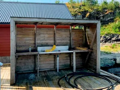 a woodenshed with a bunch of bananas on a table at 6 person holiday home in Austrheim in Utkeila