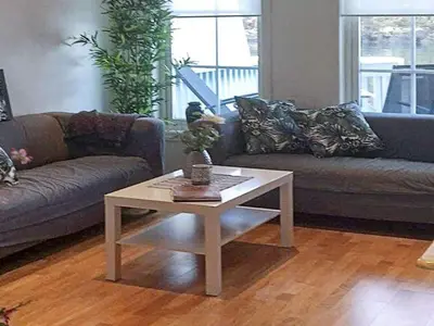 a living room with a couch and a coffee table at 6 person holiday home in Austrheim in Utkeila