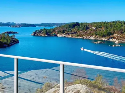 a view of a river with a boat in the water at 12 person holiday home in Fitjar in Fitjar