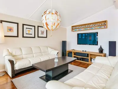 a living room with two white couches and a table at 12 person holiday home in Fitjar in Fitjar