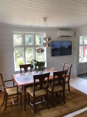 a dining room with a wooden table and chairs at Tunold Gård - Freden in Stryn