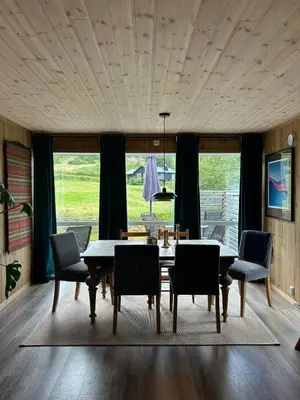 a dining room with a table and chairs at Tuddal Hyttegrend HYTTA KÅNS in Tuddal