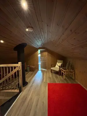a room with a red rug on a wooden floor at Tuddal Hyttegrend HYTTA KÅNS in Tuddal