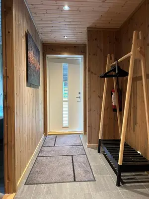 a room with a door and a staircase in a room at Tuddal Hyttegrend HYTTA KÅNS in Tuddal