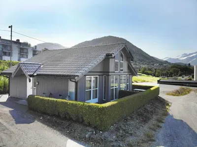 a small house with bushes in front of it at Aursnes Hotell in Sykkylven